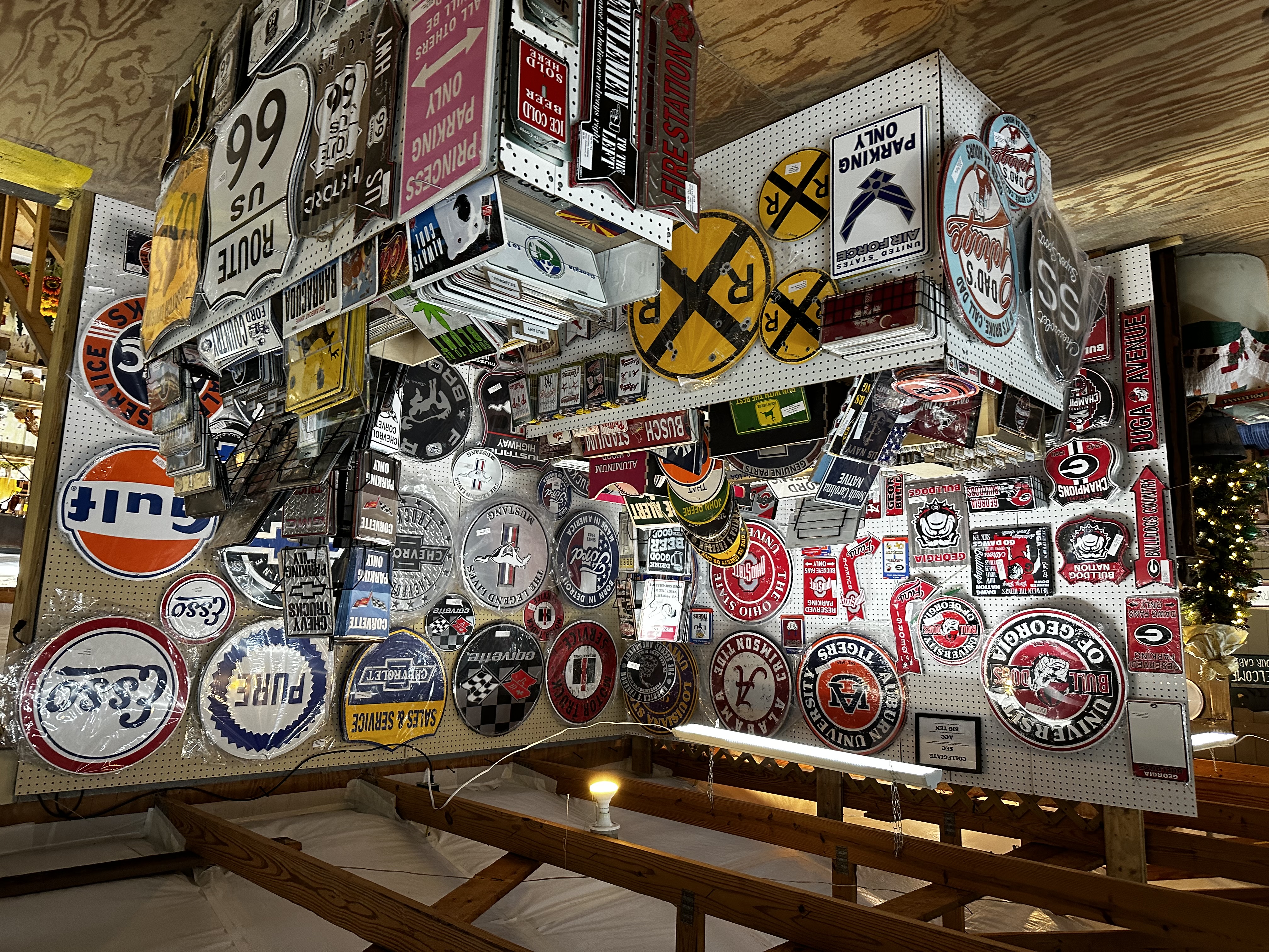 Tag City kiosk display featuring collegiate, automotive and Americana novelty signs